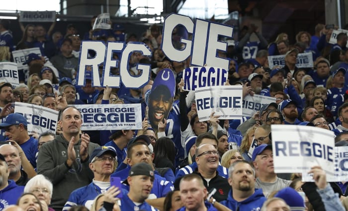 Indianapolis Colts fans salute wide receiver Reggie Wayne during his 2018 induction into the Colts Ring of Honor at Lucas Oil Stadium.
